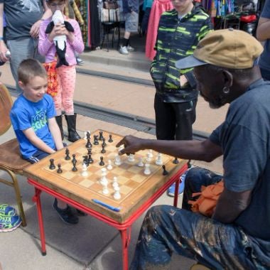 2017 Five Points Jazz Festival, child and adult playing chess, photo by Steve Hostetler 380x380